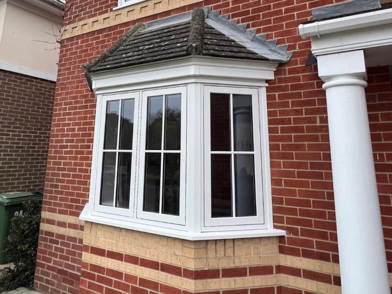 White uPVC flush fit casement windows on a bay window